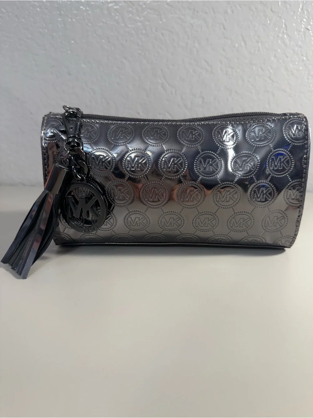 Michael Kors Shiny Silver MK Embossed Tassel Cosmetic Pouch